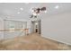 Open loft area with neutral carpet, natural lighting, and a view of the staircase and railing at 315 Wood Duck Loop, Mooresville, NC 28117