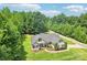 Aerial view of a beautiful home surrounded by lush greenery and a private driveway at 320 Bluegill Ln, Statesville, NC 28625