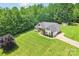 Aerial view of a lovely home, showcasing its spacious lawn, charming shed, and long driveway at 320 Bluegill Ln, Statesville, NC 28625