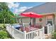 Back deck has an outdoor seating area, a grill, a hot tub, and a white railing at 320 Bluegill Ln, Statesville, NC 28625