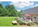 The sprawling backyard features a deck, firepit, lush lawn, mature trees, and a relaxing hammock at 320 Bluegill Ln, Statesville, NC 28625