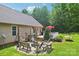 Backyard features a multi-level deck, a fire pit area, swing, hammock, and mature landscaping at 320 Bluegill Ln, Statesville, NC 28625