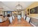 Open dining area with a wooden table and chandelier, connected to the living room and kitchen at 320 Bluegill Ln, Statesville, NC 28625