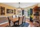 Elegant dining room featuring a stylish chandelier, rustic wall art, and hardwood flooring at 320 Bluegill Ln, Statesville, NC 28625