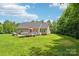 Beautiful single-story home featuring an inviting deck, spacious lawn, and a serene wooded backdrop at 320 Bluegill Ln, Statesville, NC 28625