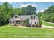 Charming two-story home with a well-manicured lawn, front garden, and inviting entrance at 320 Bluegill Ln, Statesville, NC 28625