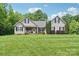 Inviting single-story home boasts a well-kept lawn and a charming covered front porch at 320 Bluegill Ln, Statesville, NC 28625