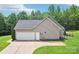 Attached two-car garage with a concrete driveway and manicured lawn at 320 Bluegill Ln, Statesville, NC 28625
