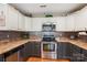 This is a kitchen with stainless steel appliances and white cabinets at 320 Bluegill Ln, Statesville, NC 28625