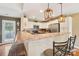 This kitchen features an island with seating and a door to the outdoor area at 320 Bluegill Ln, Statesville, NC 28625