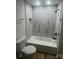 Beautiful bathroom featuring a tub, shower and toilet, accented by marble-patterned tiling at 39 E White St, Chester, SC 29706