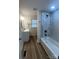 Updated bathroom with tub, shower, marble tiling and modern fixtures, leading to vanity at 39 E White St, Chester, SC 29706