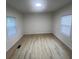 Bright bedroom with wood-look floors and two large windows providing lots of natural light at 39 E White St, Chester, SC 29706