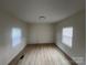 Bright bedroom featuring updated flooring and natural light from two large windows at 39 E White St, Chester, SC 29706