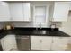 Kitchen with stainless steel dishwasher, ample sink and plenty of storage space with white cabinets at 39 E White St, Chester, SC 29706