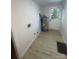 Functional laundry room featuring wood-look vinyl floors, washer/dryer hookups, and a door to the exterior at 39 E White St, Chester, SC 29706
