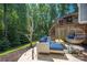 Backyard featuring a lounge area, forest views, string lights, and an upper-level deck at 3902 Mcgee Point Rd, Terrell, NC 28682