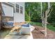 Inviting backyard features an egg chair, comfortable outdoor furniture, string lights, and forest at 3902 Mcgee Point Rd, Terrell, NC 28682