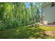 A lush green backyard bordering a dense, mature forest provides a private and serene outdoor space for this lovely home at 3902 Mcgee Point Rd, Terrell, NC 28682