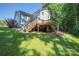 A charming two-story home featuring a wooden deck and a spacious, well-manicured backyard, ideal for relaxation and outdoor enjoyment at 3902 Mcgee Point Rd, Terrell, NC 28682