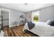 Well-lit bedroom featuring hardwood floors, natural light, and a cozy aesthetic at 3902 Mcgee Point Rd, Terrell, NC 28682