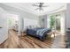 Cozy main bedroom featuring tray ceilings, a ceiling fan, deck access and stylish decor at 3902 Mcgee Point Rd, Terrell, NC 28682