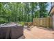 Deck featuring a grill, natural wood, greenery, and surrounded by mature trees and fencing at 3902 Mcgee Point Rd, Terrell, NC 28682