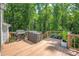 Spacious deck perfect for outdoor cooking with a grill, beautiful green forest in the background at 3902 Mcgee Point Rd, Terrell, NC 28682