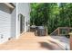 Outdoor deck, featuring grilling area, siding, and surrounded by mature trees and forest at 3902 Mcgee Point Rd, Terrell, NC 28682