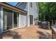 Side view of an outdoor deck with a grilling area, siding, and surrounded by mature trees at 3902 Mcgee Point Rd, Terrell, NC 28682
