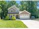 Charming two-story home with a well-manicured lawn, an attached two-car garage and mature trees at 3902 Mcgee Point Rd, Terrell, NC 28682