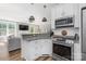 Open kitchen with granite countertops, white cabinets, stainless steel appliances, and bar seating at 3902 Mcgee Point Rd, Terrell, NC 28682