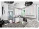 Well-lit kitchen with white cabinets, subway tile backsplash, and a spacious granite countertop at 3902 Mcgee Point Rd, Terrell, NC 28682