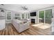 Cozy living room featuring a fireplace, ceiling fan and large sliding door to the exterior at 3902 Mcgee Point Rd, Terrell, NC 28682