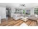 Bright, open-concept living room boasts stylish furniture and seamless transition to kitchen at 3902 Mcgee Point Rd, Terrell, NC 28682