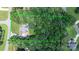 Aerial view of a home on a large lot surrounded by lush trees with a green border at 4007 Black Oak Rd, Hickory, NC 28602