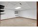Carpeted basement space with a popcorn ceiling, neutral walls and ample natural light at 4007 Black Oak Rd, Hickory, NC 28602