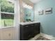 Bathroom featuring a double vanity, decorative mirrors, and plenty of natural light at 4007 Black Oak Rd, Hickory, NC 28602