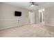 Large bedroom with neutral carpeting, a ceiling fan, and access to an ensuite bathroom at 4007 Black Oak Rd, Hickory, NC 28602