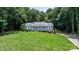 Charming single-story home with a manicured lawn, surrounded by lush trees and a welcoming front porch at 4007 Black Oak Rd, Hickory, NC 28602