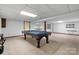 Billiards table set in a game room with a tiled ceiling and carpet floors at 4007 Black Oak Rd, Hickory, NC 28602