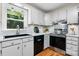 Well-lit kitchen with white cabinets, stainless steel appliances, and hardwood floors at 4007 Black Oak Rd, Hickory, NC 28602