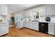 Charming kitchen featuring bright white cabinets, modern appliances, and hardwood flooring at 4007 Black Oak Rd, Hickory, NC 28602