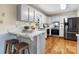 Modern kitchen with white cabinets, stainless steel appliances, and a breakfast bar at 4007 Black Oak Rd, Hickory, NC 28602