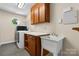 Functional laundry room featuring a utility sink, a washing machine, and cabinetry for storage at 4007 Black Oak Rd, Hickory, NC 28602