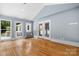 Spacious living room featuring hardwood floors, large windows, and a vaulted ceiling at 4007 Black Oak Rd, Hickory, NC 28602