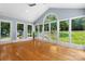 Bright sunroom with large windows offering scenic backyard views and gleaming hardwood flooring at 4007 Black Oak Rd, Hickory, NC 28602