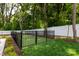 Fenced backyard featuring lush green grass and mulched garden area at 4203 Walker Rd, Charlotte, NC 28211