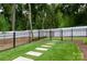 Fenced backyard featuring stepping stones in lush green grass at 4203 Walker Rd, Charlotte, NC 28211