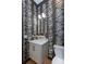 Stylish powder room features a modern vanity, gold fixtures, and unique tiger-striped wallpaper at 4203 Walker Rd, Charlotte, NC 28211